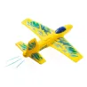 Petit planeur jaune DJECO 2100 "Fire Jet" en vol, avec ailettes bleues et traînée légère sous l'arrière.