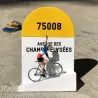 Borne kilométrique jaune et blanche avec le code 75008, affichant “AVENUE DES CHAMPS-ÉLYSÉES” et une miniature de cycliste sur un vélo.