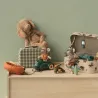 Le bateau pneumatique orange Maileg tracté par le tricycle vert et sa souris portant son gilet. Décor Maileg avec pêcheur, peluche chien et valisette.