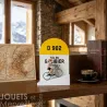 Borne kilométrique jaune D 902 « Gol du Galibier » avec petit cycliste miniature sur bicyclette devant un livre et une carte ancienne.
