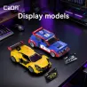 Miniatures Renault 5 Maxi Turbo de CaDA en bleu et jaune sur un bureau, avec étiquettes et éclairage violet.