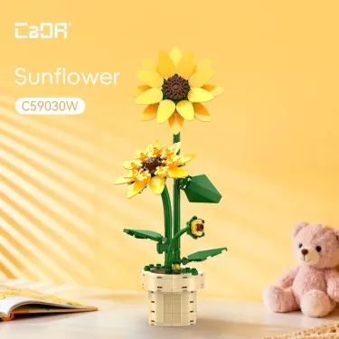 Tournesol CADA: arrangement floral en briques jaune avec pot beige et teddy bear à côté, set de construction éco déco.