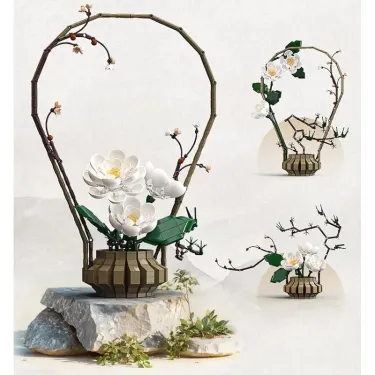Kit de construction Cada fleurs Hiver: sculpture florale en bois avec fleurs blanches et bouquet sur socle rocheux, décor hivernal.