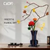 Kit de construction Cada fleurs Automne : sculpture florale orientale en pièces bricolage, vase bleu et branches décoratives avec fleurs jaunes et rouges.