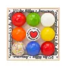 Coffret de 9 billes calots multicolores avec cœur au centre, emballage en bois, motif « j’aime les billes ».