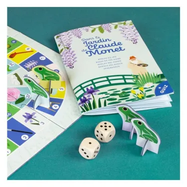 Livre de jeu “Dans le jardin de Claude Monet” avec pions animaux, dès et plan du jeu sur fond turquoise.